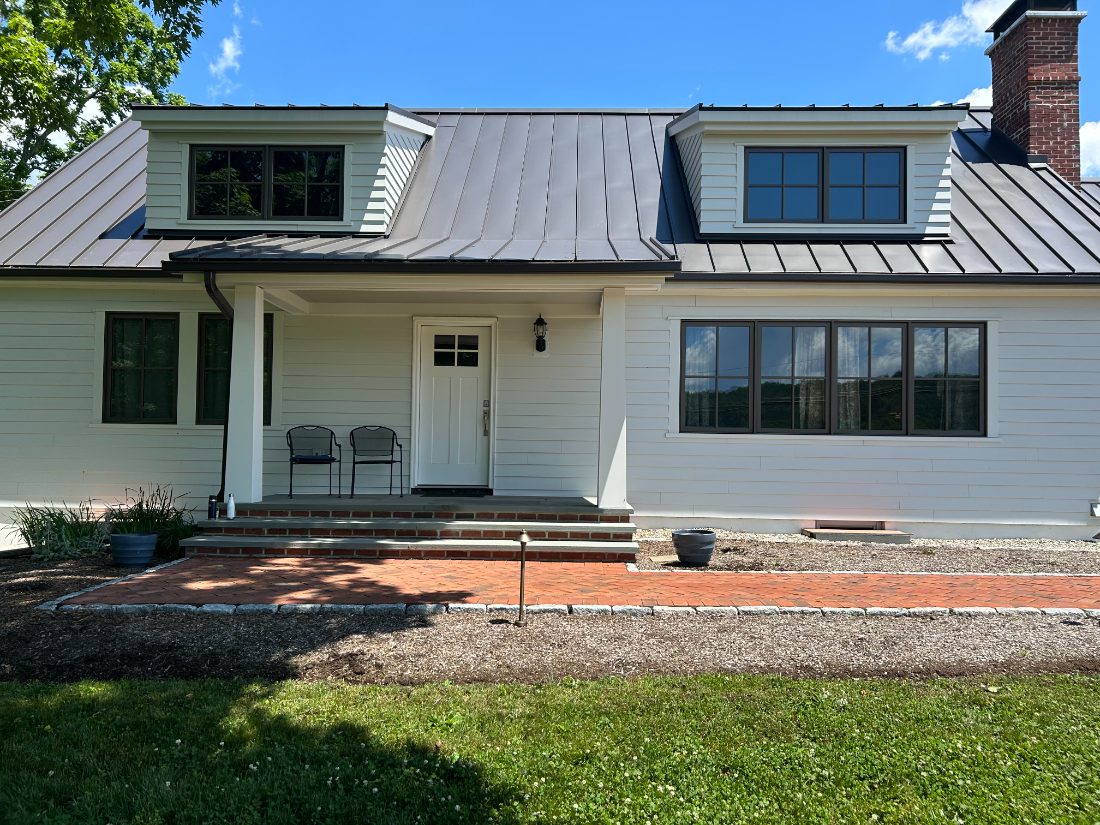 New-build farmhouse exterior with standing-seam metal roof — Bucks County, PA