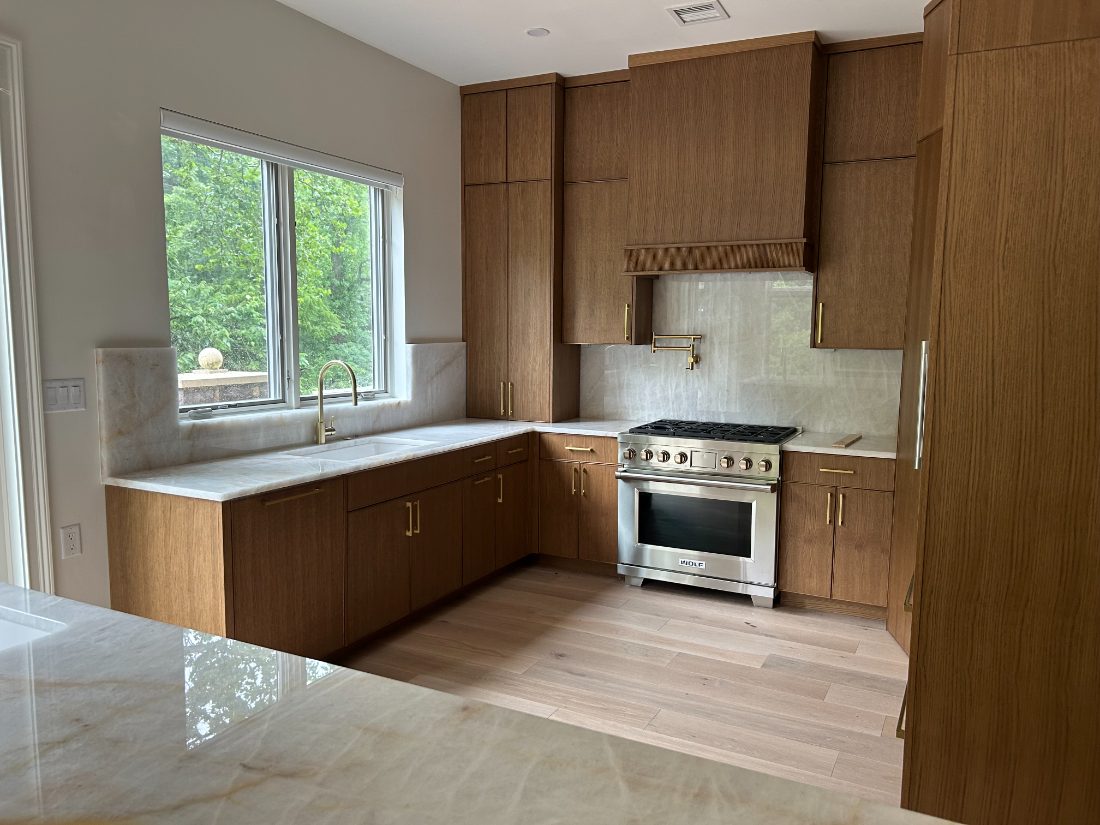 Custom white-oak kitchen with Wolf range and quartzite counters