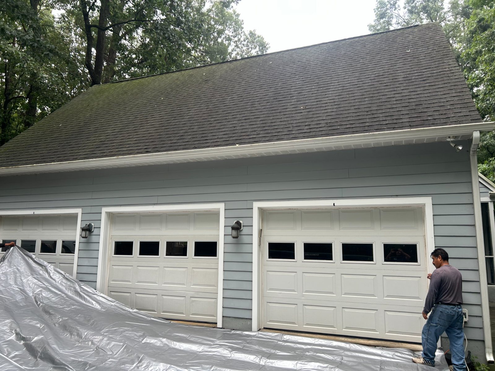 Three-bay garage tarped and prepped before roof work